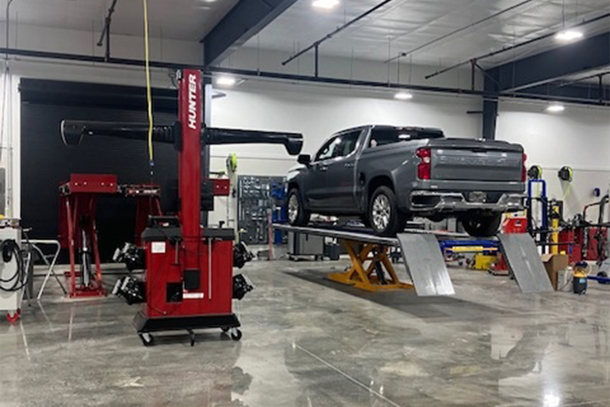 Workers working on the body of a vehicle.