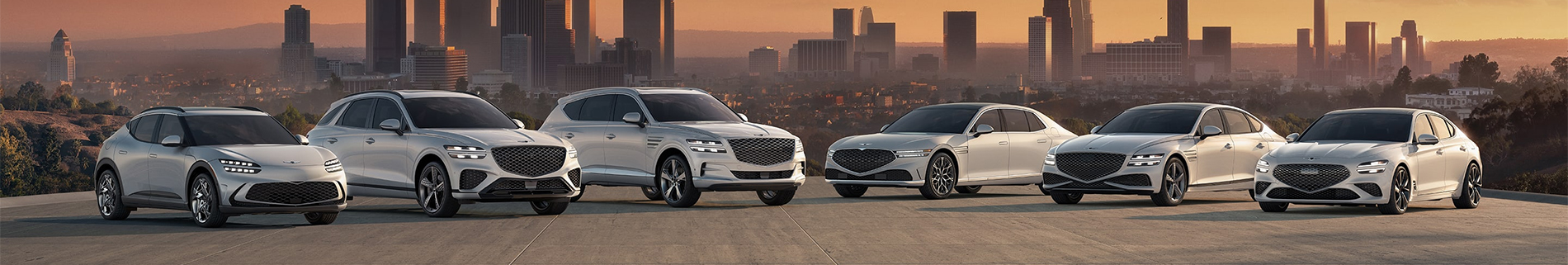 Genesis GV60, GV70, GV80, G90, G80, and G70 shown parked together on a rooftop overlooking a city at sunset.