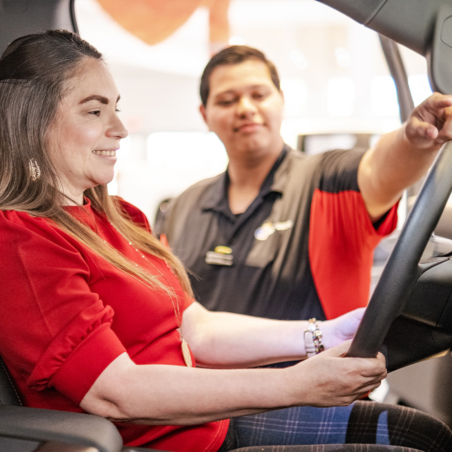 Bert Ogden employee showing a customer the interior of a vehicle