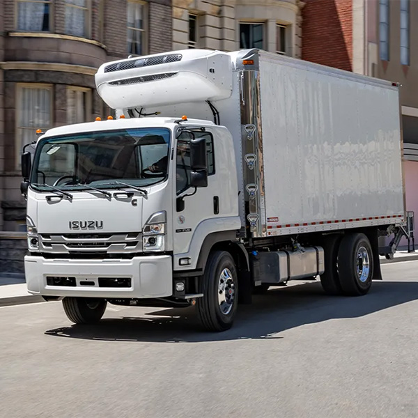 ISUZU Truck in motion driving through the city