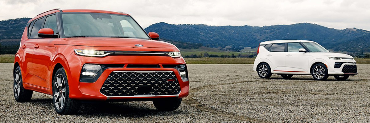 red and white 2020 Kia Souls parked with mountains in the backround