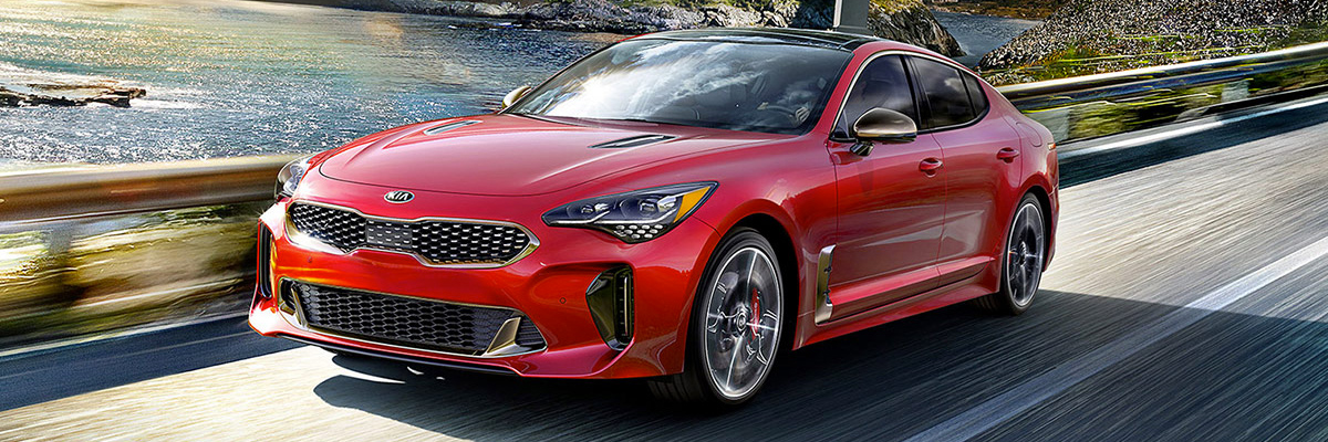red 2019 Stinger shown driving on a coastal road
