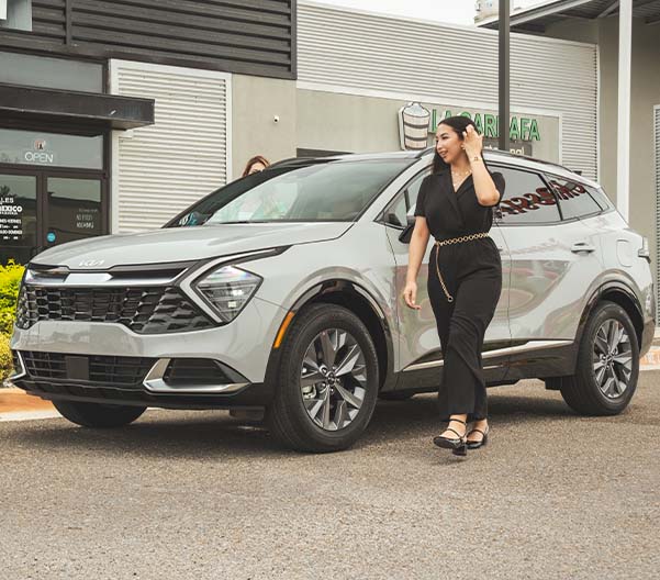 Two women stepping out of their New Kia.