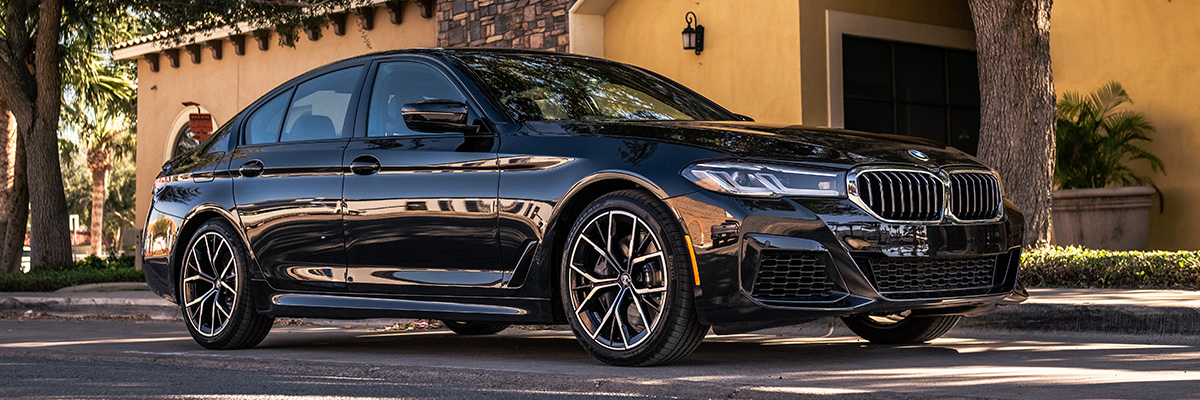 BMW sedan parked outside a home