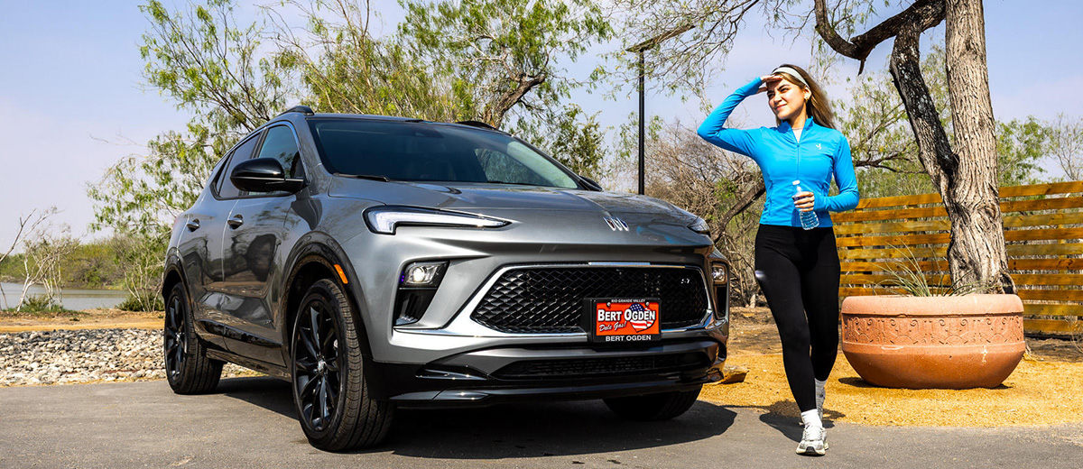 Woman standing next to her Buick SUV