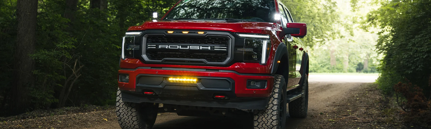 Side profile shot of the Roush F-150 driving down dirt road.
