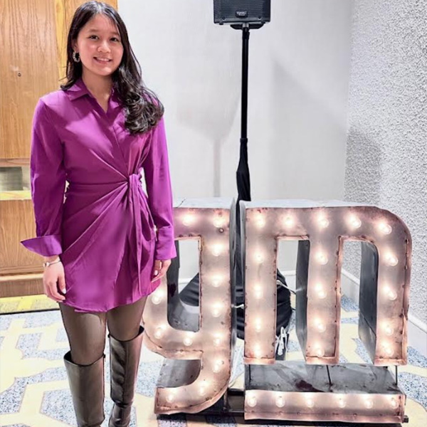 Woman next to GM sign