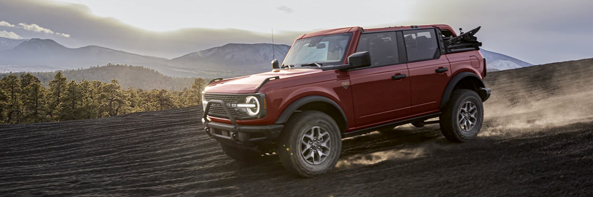 2021 Ford® Bronco four door Badlands™ in Rapid Red being driven in the mountains