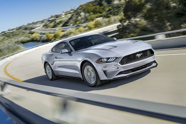 A 2021 Ford Mustang being driven around a curve