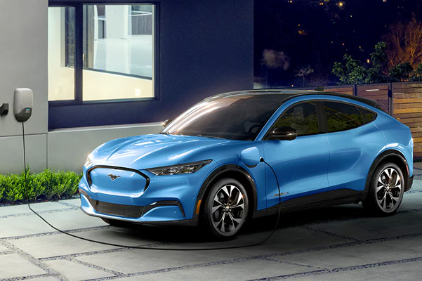A 2022 Ford Mustang Mach-E plugged into an at-home charging station