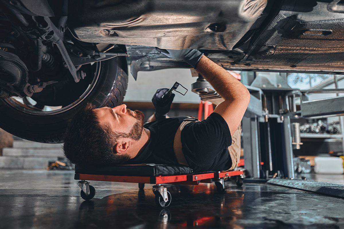 Technician working underneath vehicle