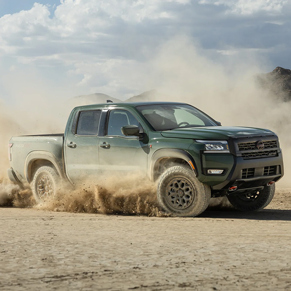 Front view of Nissan Frontier driving through desert