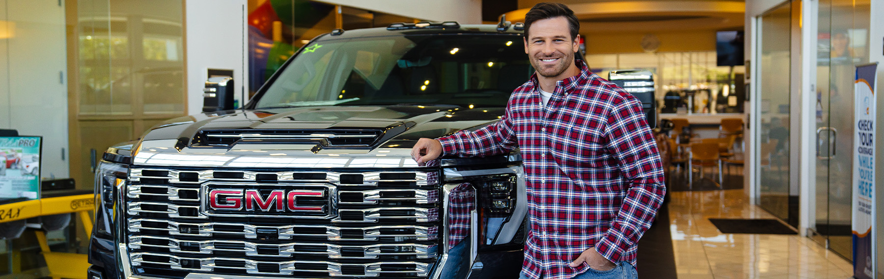 Man standing next to a GMC vehicle