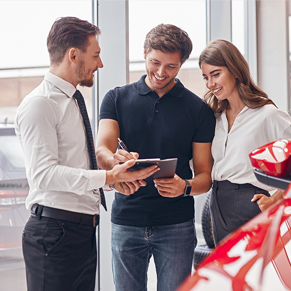 Dealership employee smiling with customers