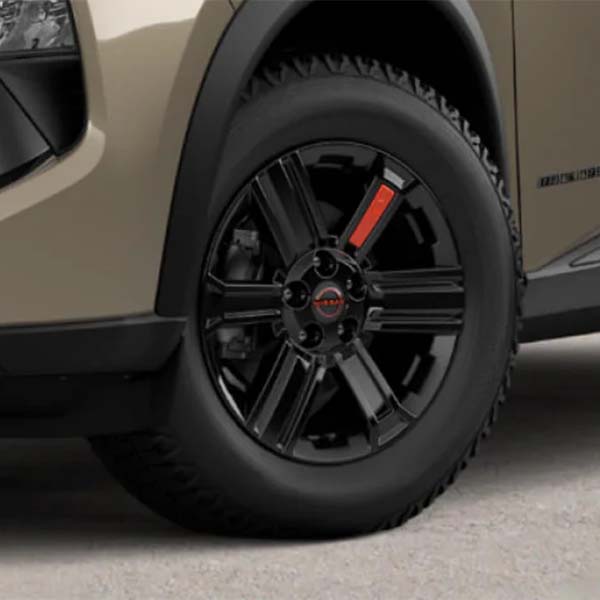 Close-up of a black car wheel with red details.