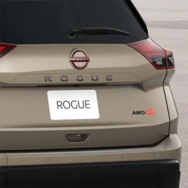 Rear view of a beige Nissan Rogue car.