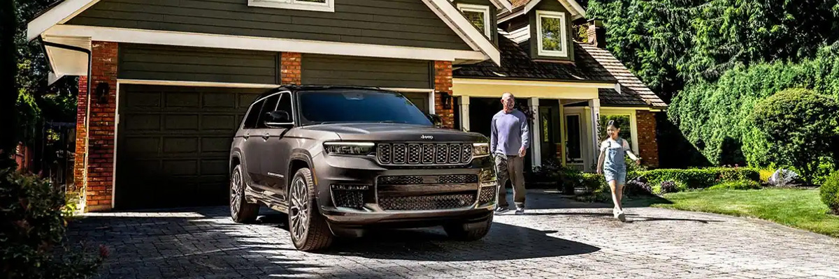 New Jeep Grand Cherokee parked in a family's driveway